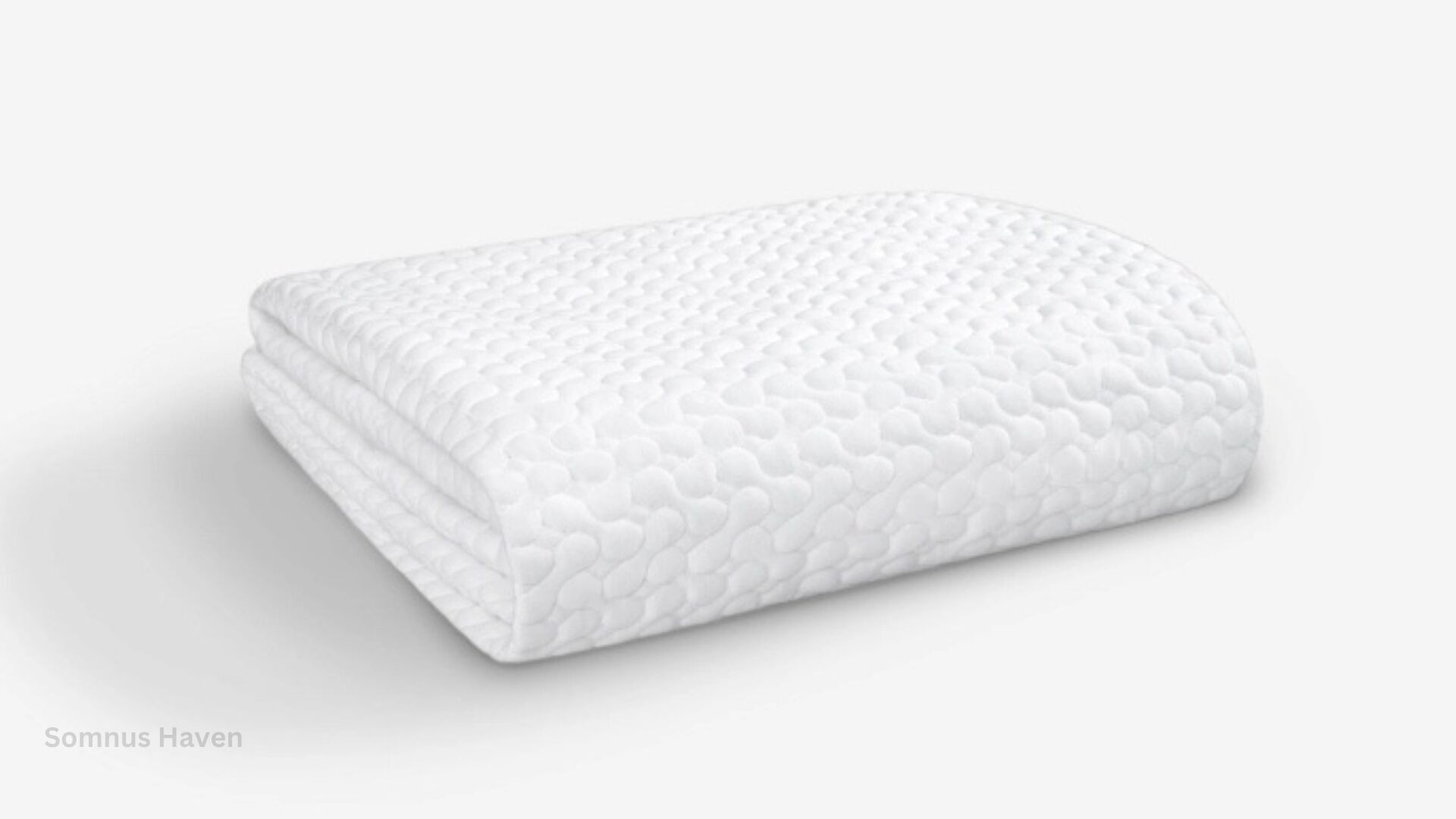 Textured white ergonomic pillow for comfort and support in a minimalist setting.