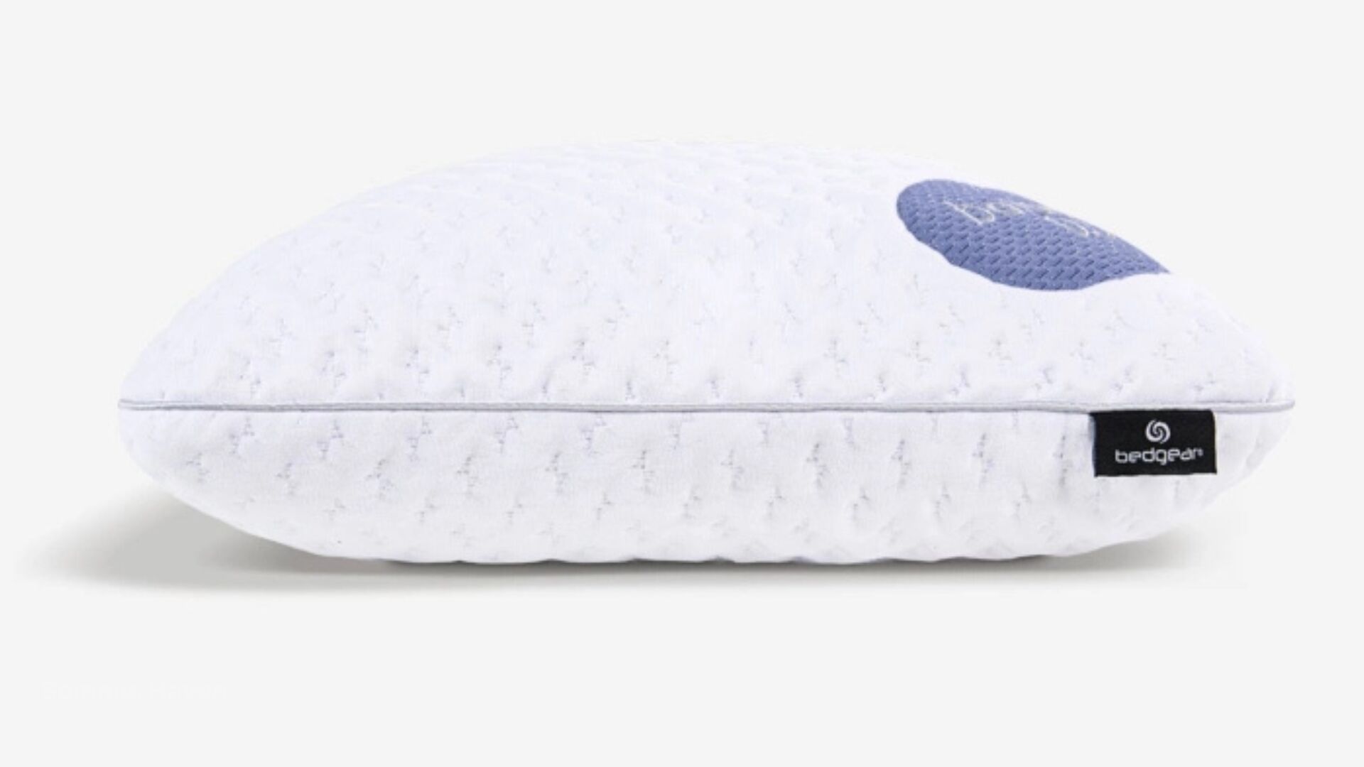 Modern white pillow with oval design and blue cooling patch for ergonomic comfort.