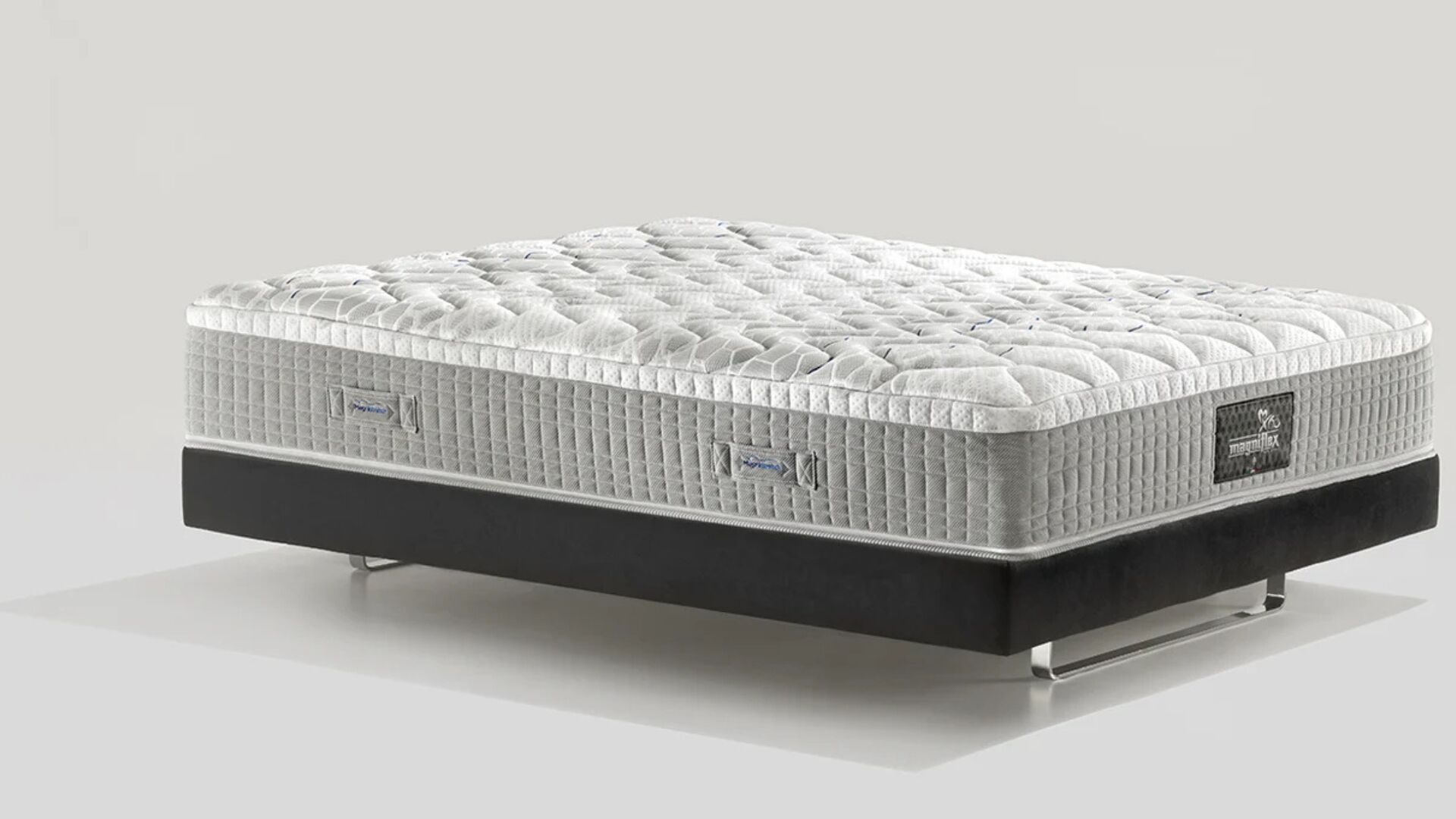 Luxurious modern mattress with plush quilting on a sleek, contrasting platform base.