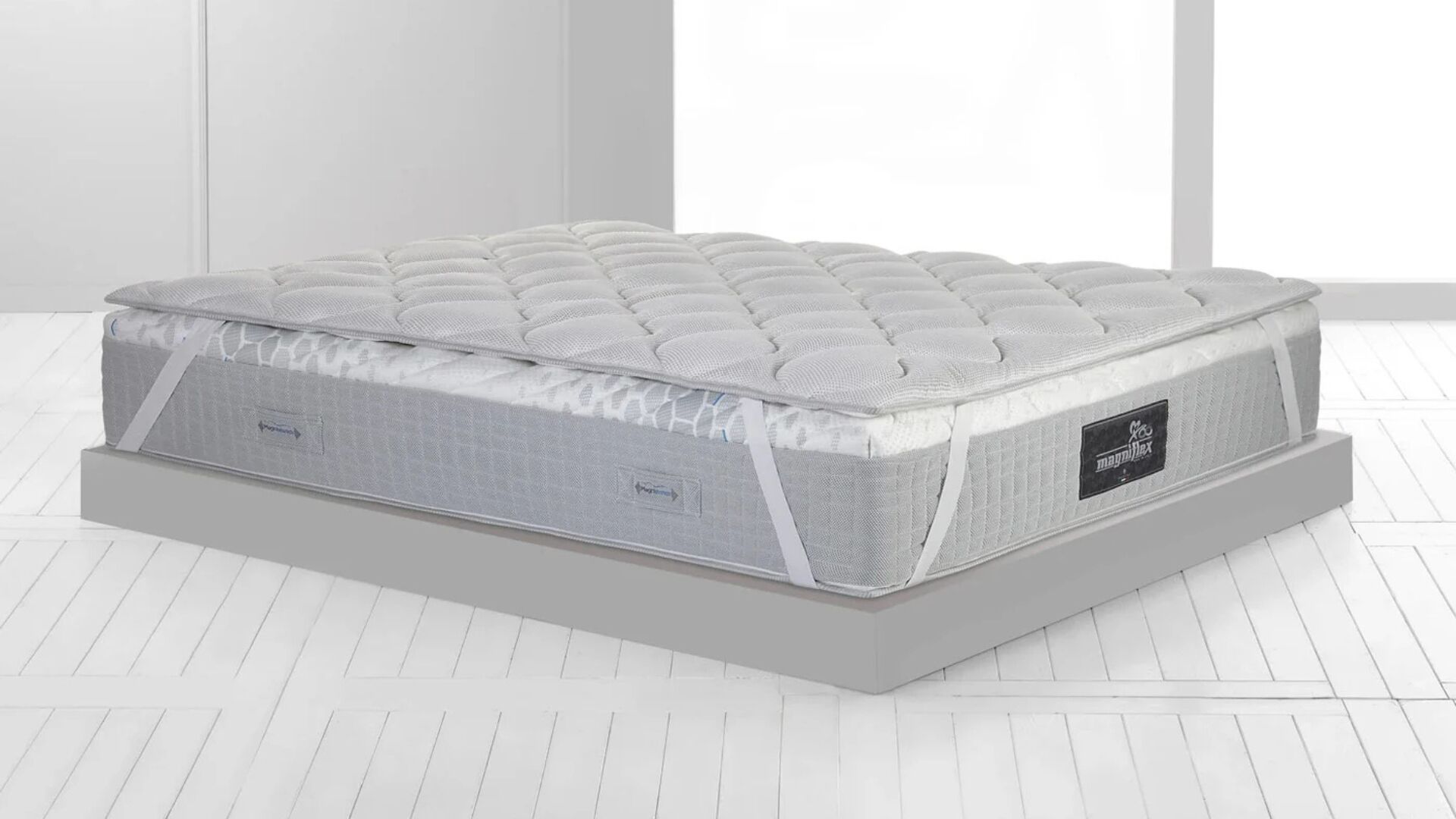 Plush gray quilted mattress in minimalist setting, emphasizing elegance and comfort.