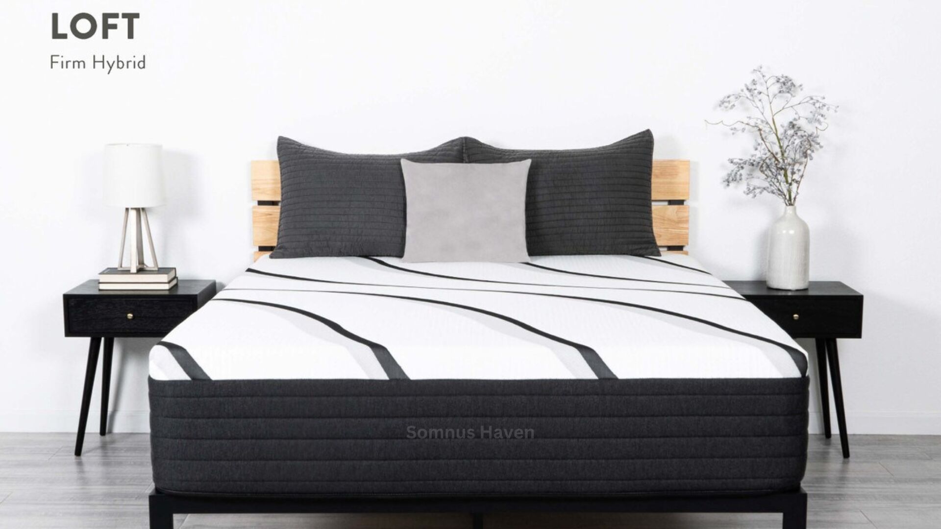 Modern bedroom with LOFT Firm Hybrid mattress, gray pillows, wooden bed, and nightstands.