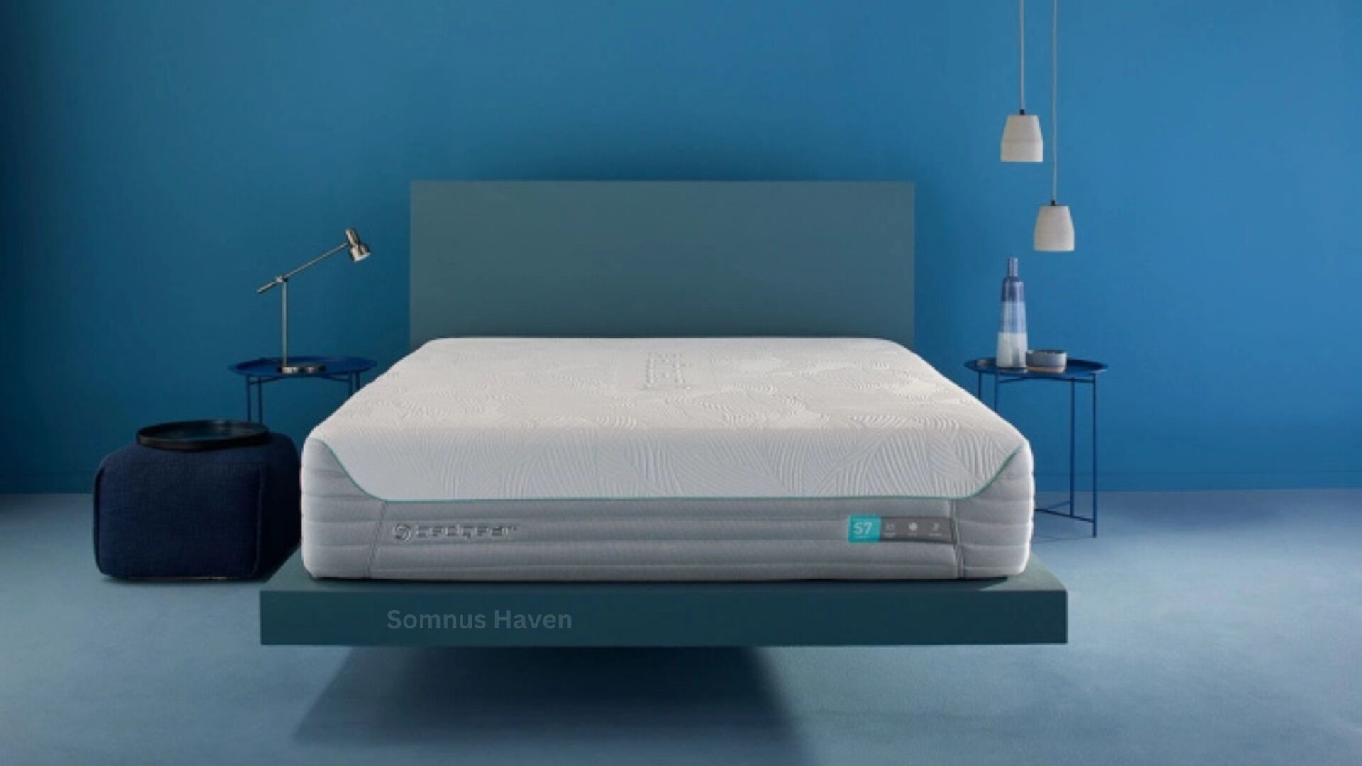 Modern minimalist bedroom with blue accent wall, floating bed, and stylish nightstands.