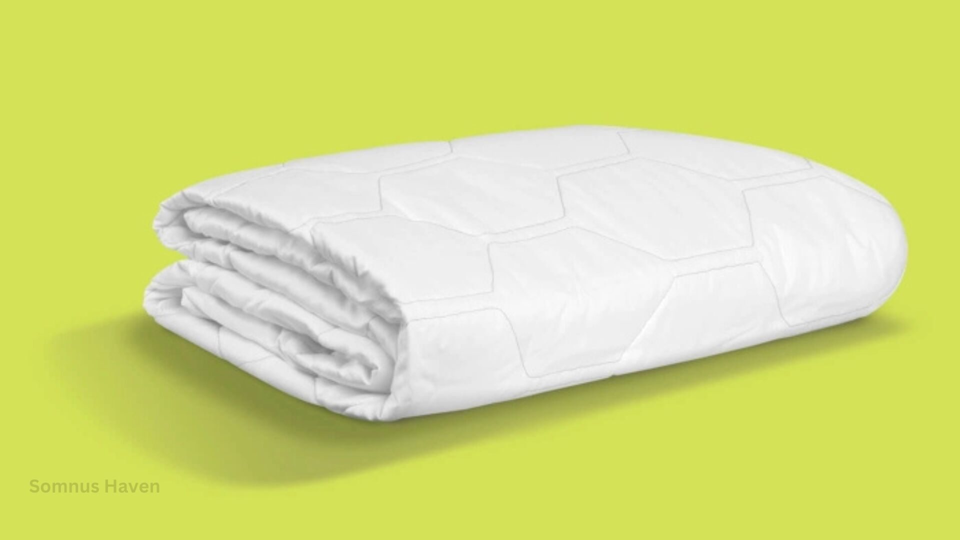 White comforter with quilting on lime green background, highlighting modern design and craftsmanship.