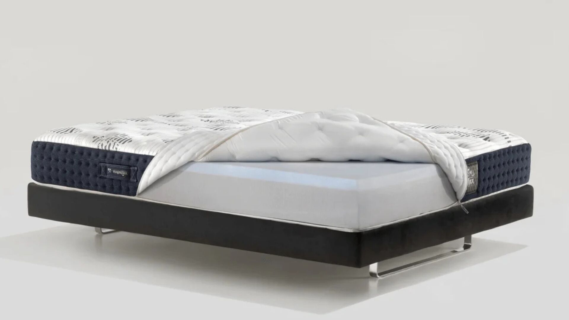 Modern luxury mattress with memory foam on a sleek black frame for optimal comfort.