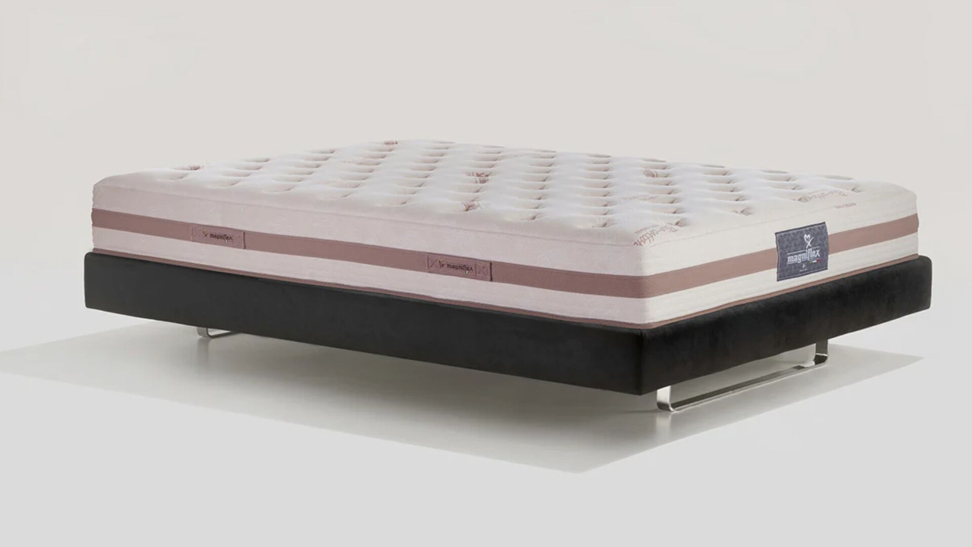 Luxury tufted mattress on sleek frame enhances modern bedroom decor.