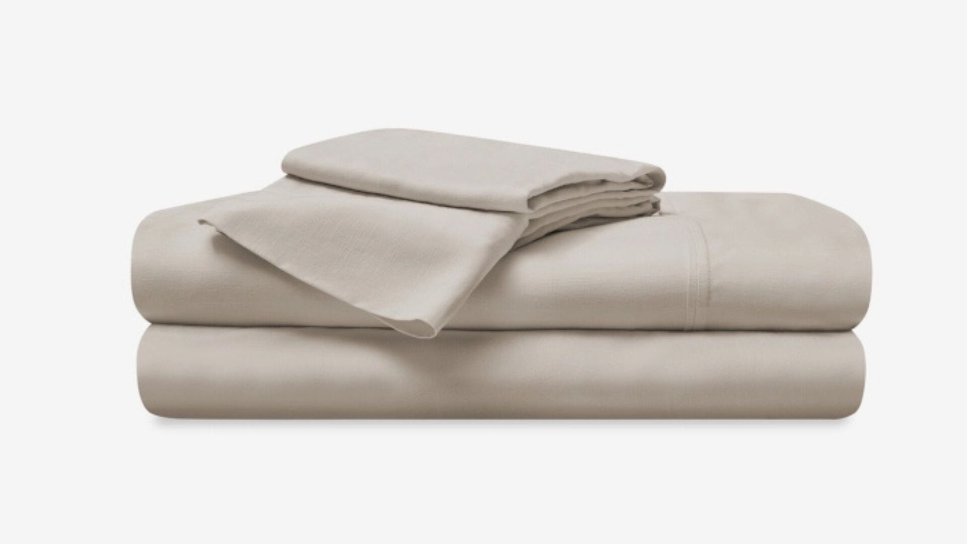 Neatly stacked taupe bedding sheets evoke comfort and tranquility for restful sleep.