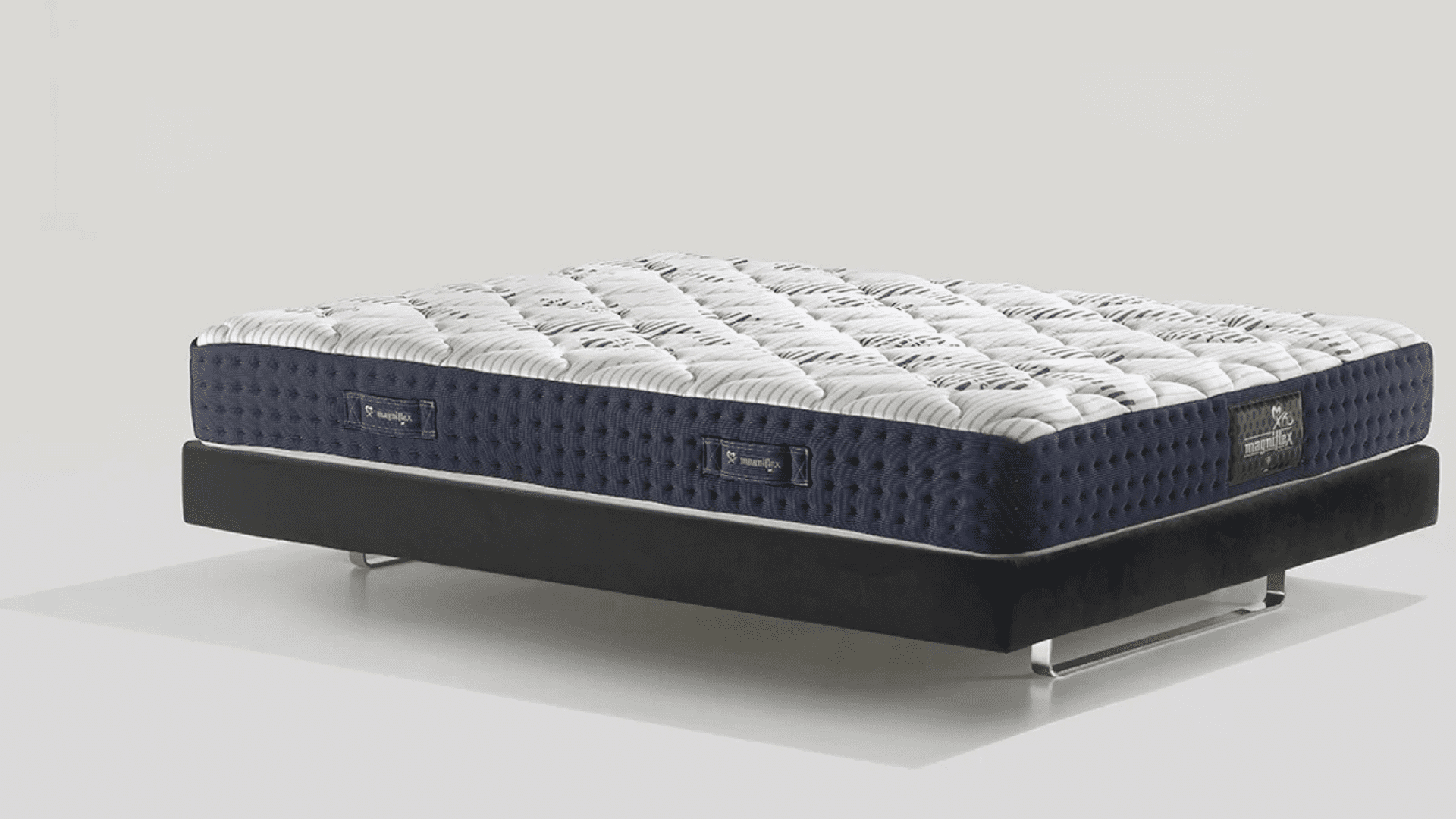 Luxurious modern mattress with quilted design, navy-blue border, and sleek metal frame.