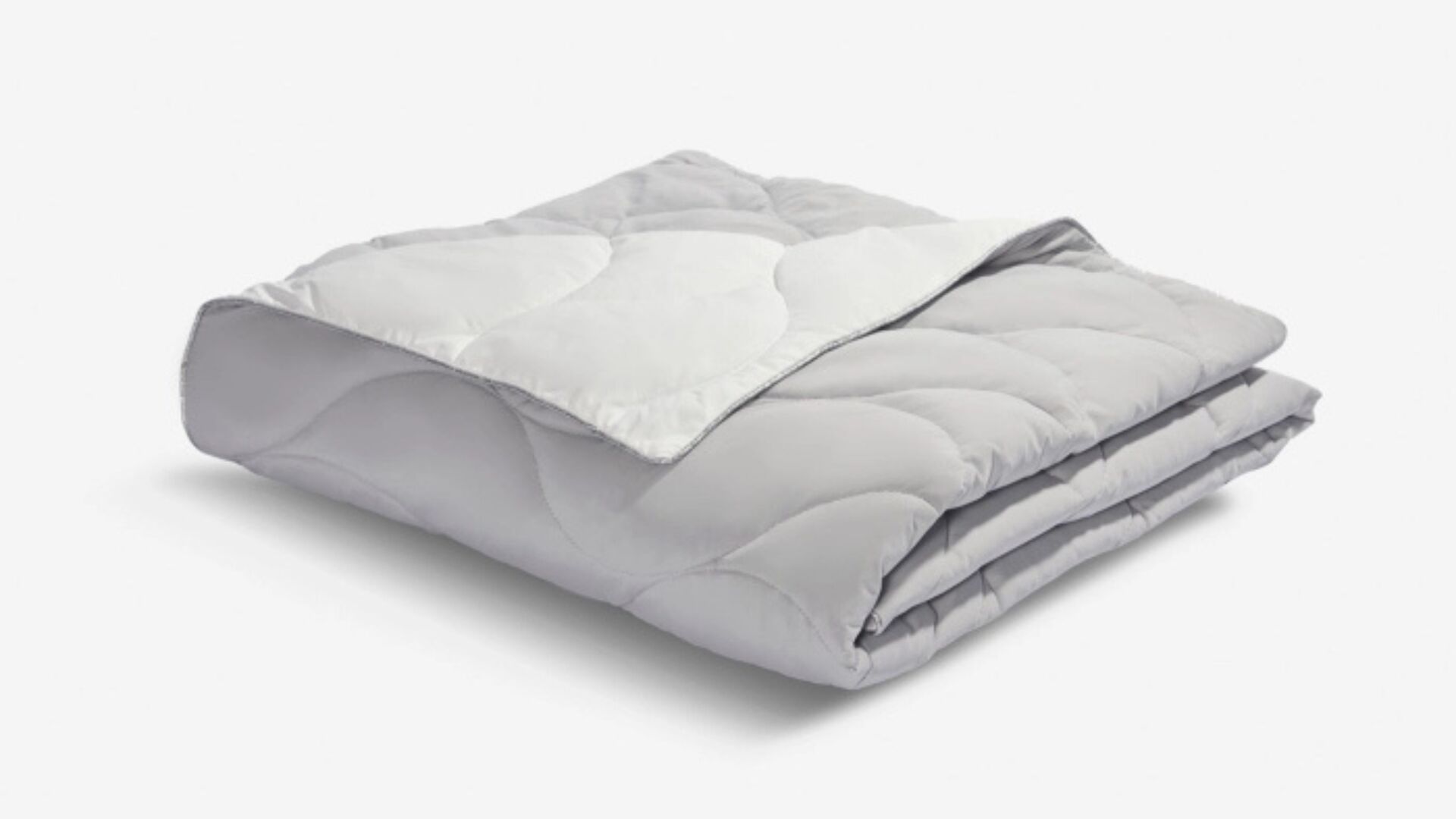 Soft grey quilted comforter for warmth and style in any bedroom or living space.